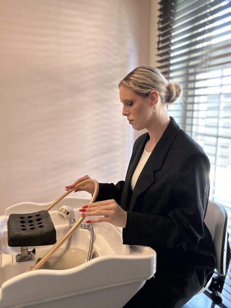 Therapist preparing the head spa basin at partner salon Belliza