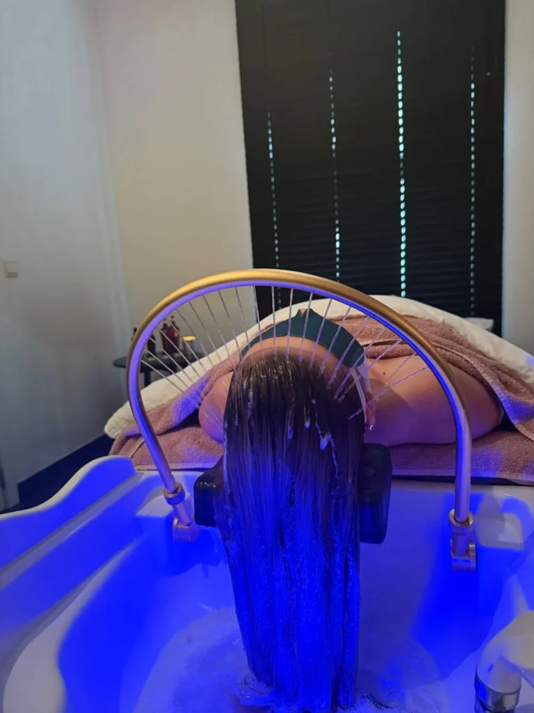 Head spa rinse under blue light therapy at partner salon Belliza